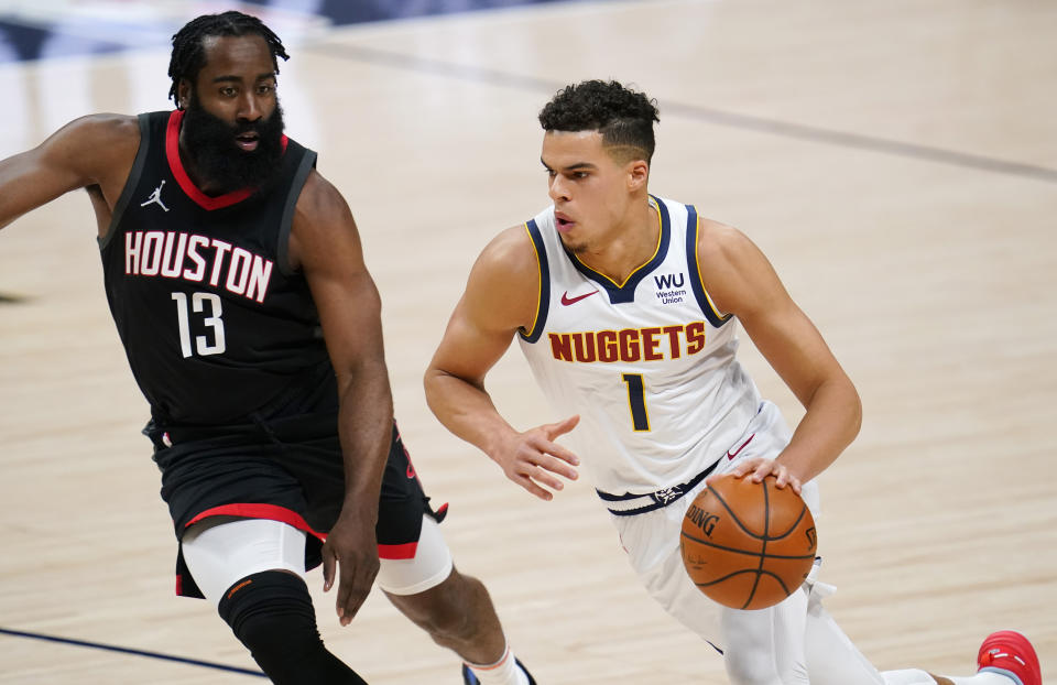 Denver Nuggets forward Michael Porter Jr., right, drives as Houston Rockets guard James Harden defends during the first half of an NBA basketball game Monday, Dec. 28, 2020, in Denver. (AP Photo/David Zalubowski)