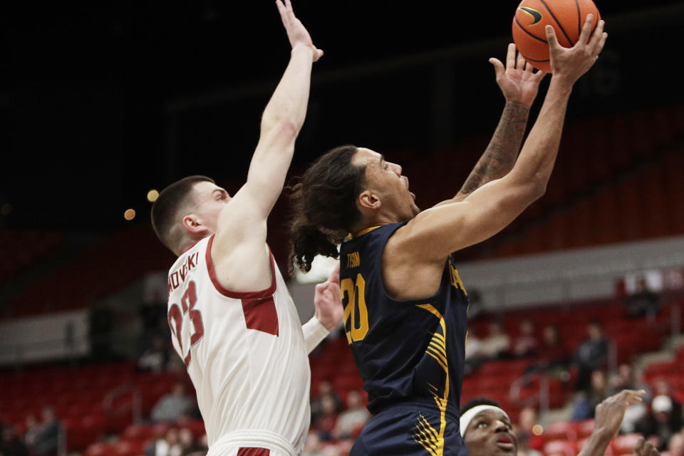 California guard Jaylon Tyson (20) drives to the basket while defended by Washington State forward Andrej Jakimovski (23) during the first half of an NCAA college basketball game Thursday, Feb. 15, 2024, in Pullman, Wash. (AP Photo/Young Kwak)