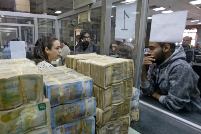 Syrians trying to withdraw money in Damascus in November amid growing economic pressure (AFP via Getty)