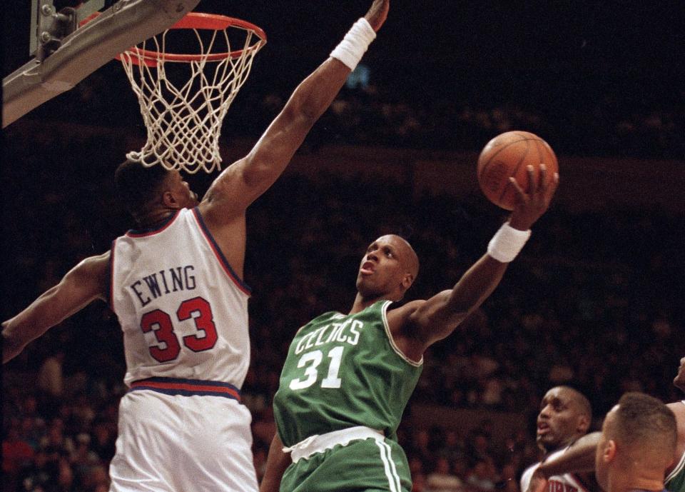 Xavier McDaniel (31) of the Boston Celtics shoots over the outstretched arms of Patrick Ewing (33) of the New York Knicks during NBA action at Madison Square Garden in New York, Jan. 11, 1993. The Celtics outlasted a lasted a late Knicks surge to win 100-97. AP Photo/Ron Frehm