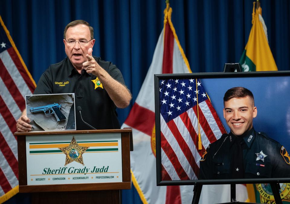 Polk County Sheriff Grady Judd holds a  photo of a BB gun Cheryl Lynn Williams pointed at  Polk County Deputies during a press conference at the Sheriffs Operation Center In Winter Haven Fl. Tuesday October 4,2022 Deputy  Lane was fatally shot early Tuesday morning in Polk City when fellow deputies opened fire on the suspect  Williams who pointed a weapon at them.
Ernst Peters/.The Ledger