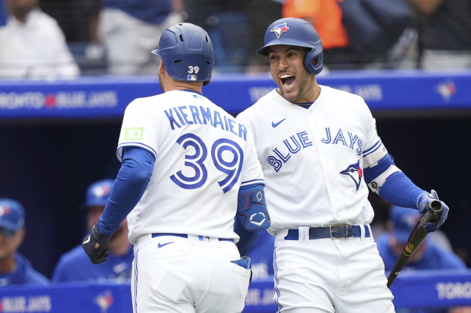 Toronto Blue Jays center fielder Kevin Kiermaier (39) celebrates with teammate George Springer after hitting a solo home run against the Kansas City Royals during the seventh inning of a baseball game in Toronto on Sunday, Sept. 10, 2023. (Nathan Denette/The Canadian Press via AP)