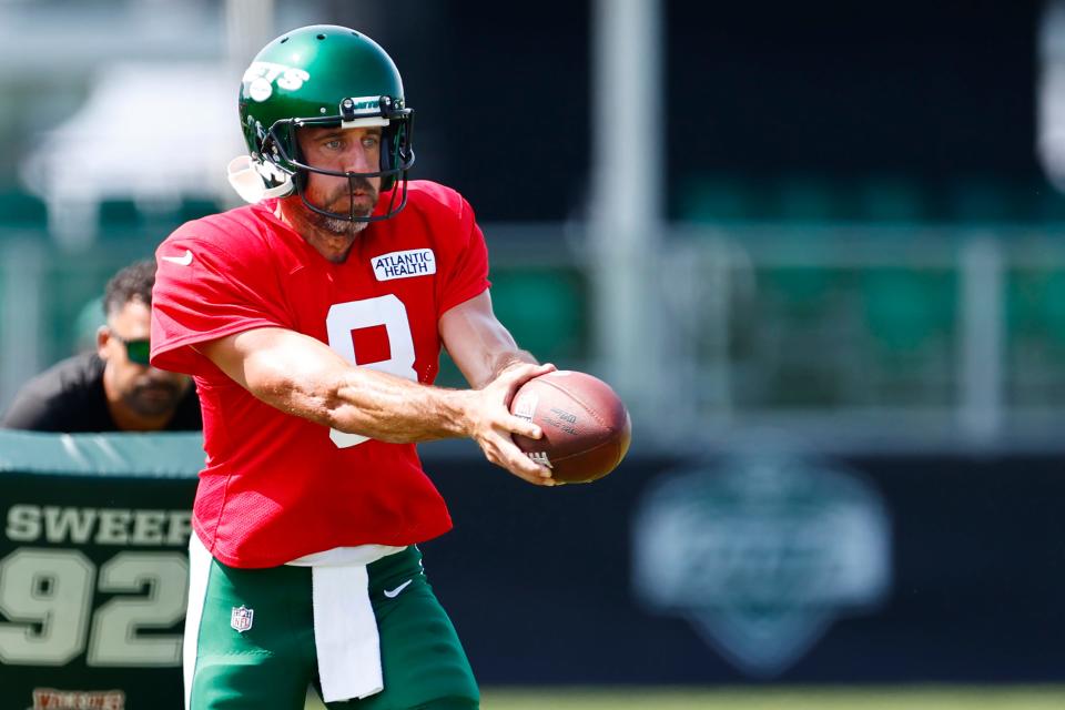 New York Jets quarterback Aaron Rodgers looks to hand off during training camp Wednesday at Atlantic Health Jets Training Center in Florham Park, New Jersey.