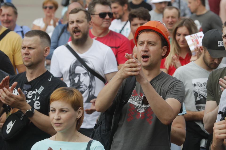 Belarusian miners shout during a rally in Salihorsk, about 120 km (75 miles) from Minsk, Belarus, Tuesday, Aug. 18, 2020. Factory workers in Belarus continued to strike on Tuesday, turning up pressure on the country's authoritarian leader to step down after winning an election they say was rigged. (AP Photo/Dmitri Lovetsky)