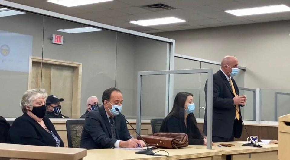 Canton City Prosecutor Jason Reese (right) files a motion to dismiss a criminal mischief charge against Hartville Councilwoman Beverly Green during a hearing Wednesday in Canton Municipal Court.