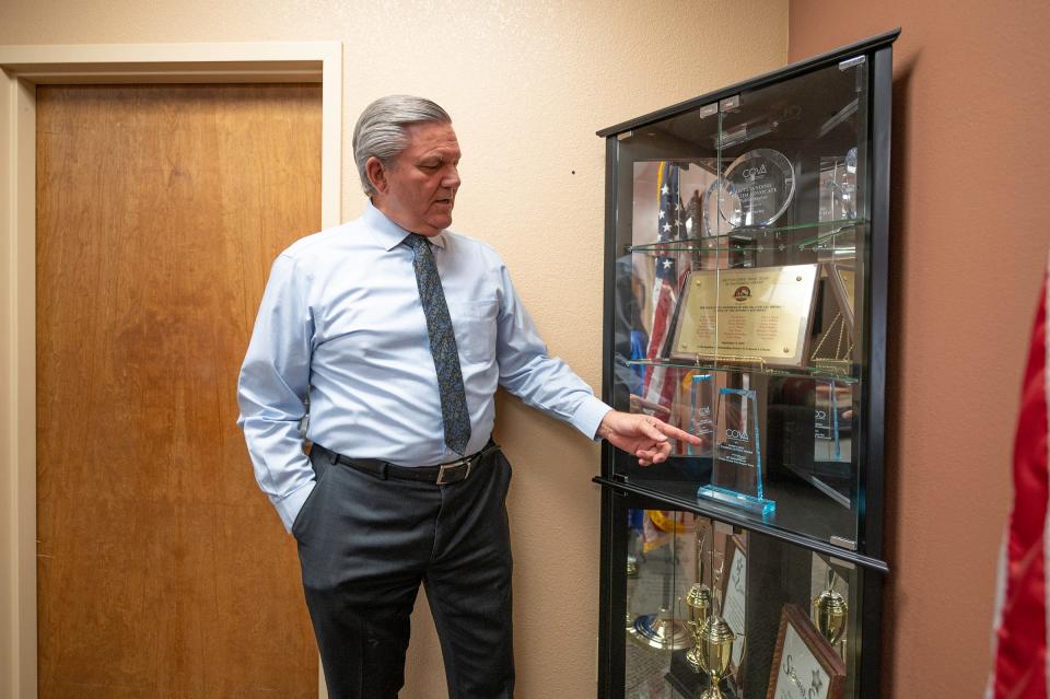 Pueblo Distict Attorney Jeff Chostner points some of the state awards his office has received over the years on Tuesday, January 30, 2024.