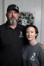 In this Oct. 12, 2021, photo, David and Wendy Mills, parents of Kailee Mills who was killed four years ago in an automobile accident when riding in the back seat without a seat belt, with a photo of their daughter at their home in Spring, Texas. The teenager was riding in the back seat of a car to a Halloween party in 2017 just a mile from her house when she unfastened her seat belt to slide next to her friend and take a selfie. Moments later, the driver veered off the road and the car flipped, ejecting her. (AP Photo/Michael Wyke)