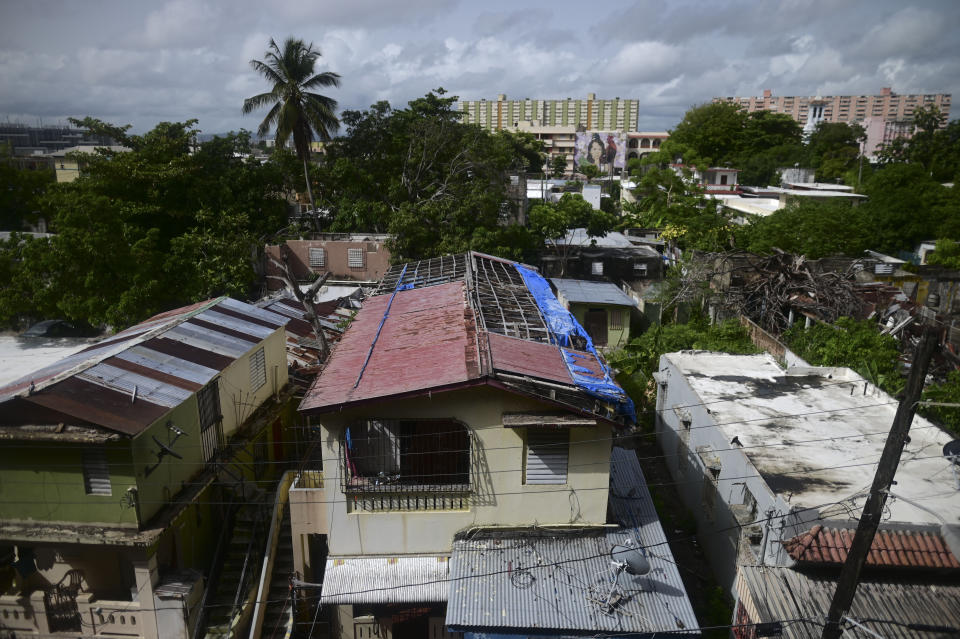 A hurricane-damaged home shows traces of a blue tarp installation in San Juan, Puerto Rico, Monday, July 13, 2020, nearly three years after Hurricane Maria tore through the island. The federally funded program R3 named for its efforts to repair, rebuild or relocate, which began in July 2019, hasn't yet finished a single home. (AP Photo/Carlos Giusti)