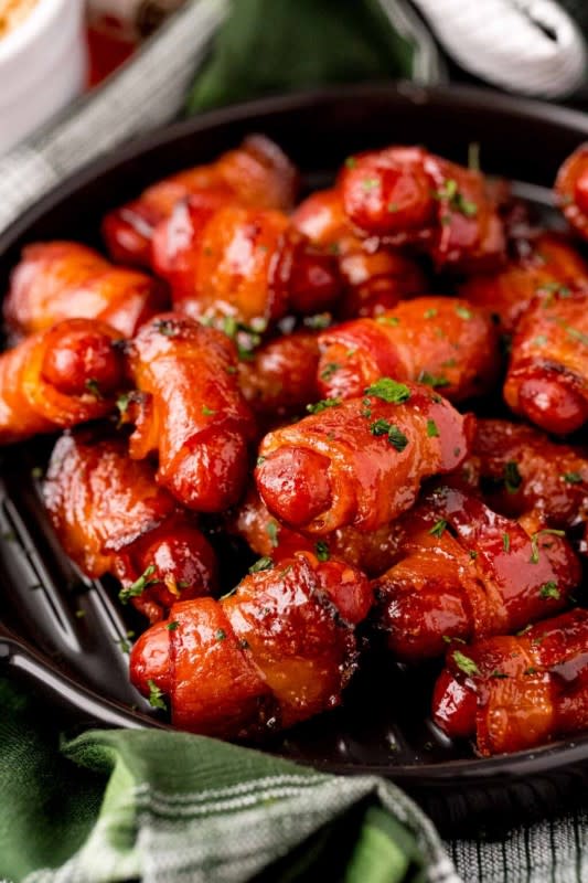 <p>Play Party Plan</p><p>Only four ingredients to this crowd-pleasing appetizer that brings the heat.</p><p><strong>Get the recipe: <a href="https://www.playpartyplan.com/bacon-wrapped-smokies" rel="nofollow noopener" target="_blank" data-ylk="slk:Hot Honey Glazed Bacon Wrapped Smokies;elm:context_link;itc:0;sec:content-canvas" class="link ">Hot Honey Glazed Bacon Wrapped Smokies</a></strong></p>