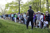 Brooks Koepka checks his line from the rough on the 13th hole during the third round of the PGA Championship golf tournament, Saturday, May 18, 2019, at Bethpage Black in Farmingdale, N.Y. (AP Photo/Julio Cortez)