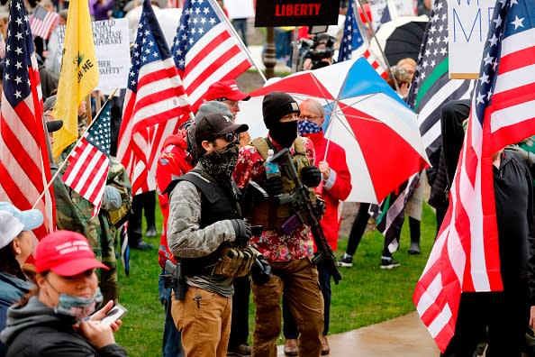 Armed protesters provide security as demonstrators take part in an "American Patriot Rally," organised by Michigan United for Liberty on the steps of the Michigan State Capitol in Lansing, demanding the reopening of businesses.