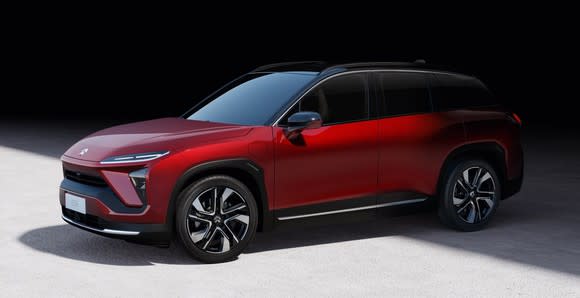 A red NIO ES6, a sleek midsize SUV.