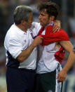 FILE - In this June 17, 2000 file photo England's coach Kevin Keegan, left, comforts Germany's captain Lothar Matthaeus at the end of the Euro 2000 group A match between England and Germany in Charleroi, Belgium. England won 1-0. (AP Photo/Michael Probst, File)