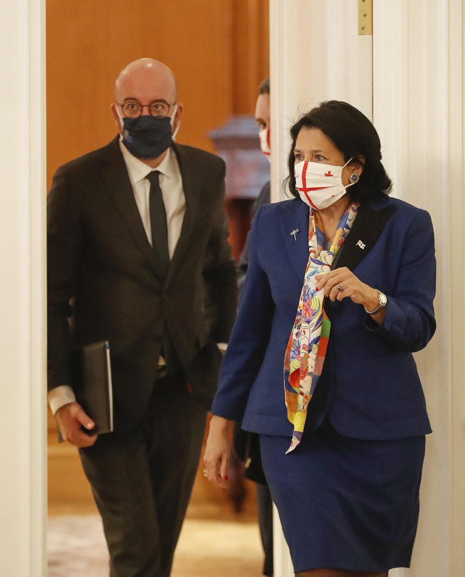 In this handout photo provided by the Georgian Presidential Press Office, Georgia's President Salome Zurabishvili, right, attends a meeting with European Council President Charles Michel in Tbilisi, Georgia, Monday, March 1, 2021 (Georgian Presidential Press Office via AP)