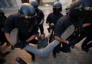 <p>Catalan police officers remove a protestor from the street outside a Unipost office which was raided in search of material for the proposed October 1 referendum, in Terrassa, Spain, Sept. 19, 2017. (Photo: Albert Gea/Reuters) </p>