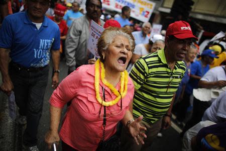 An elderly woman yells slogans during a march for peace in downtown Caracas February 23, 2014. REUTERS/Tomas Bravo