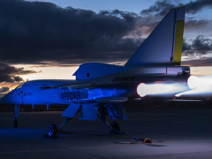 The XB-1 engines powered up with a blue light shining on the plane.