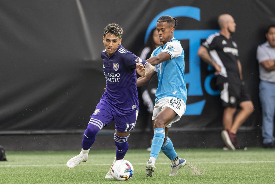 Orlando City forward Facundo Torres (17) and Charlotte FC forward Kerwin Vargas (18) fight for the ball during the first half of an MLS soccer match, Sunday, Aug. 21, 2022, in Charlotte, N.C. (AP Photo/Matt Kelley)