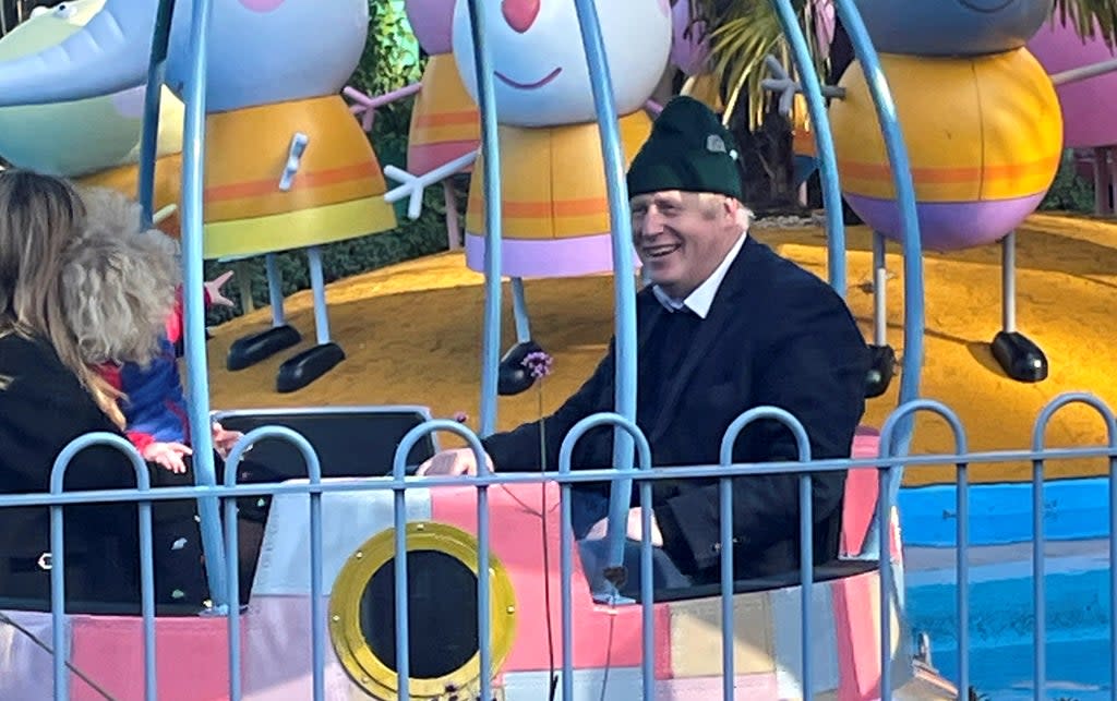 Boris and Carrie Johnson and their son Wilfred enjoy a ride at Peppa Pig World near Ower, Hampshire, last month  (Reuters)