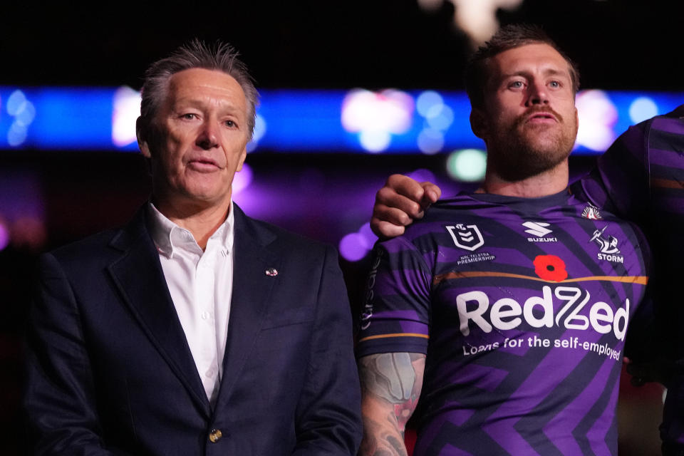 MELBOURNE, AUSTRALIA - APRIL 25: Craig Bellamy, head coach of the Storm (L) and Cameron Munster of the Storm sing the national anthem during the ANZAC Day ceremony prior to the round eight NRL match between Melbourne Storm and South Sydney Rabbitohs at AAMI Park, on April 25, 2024, in Melbourne, Australia. (Photo by Daniel Pockett/Getty Images)