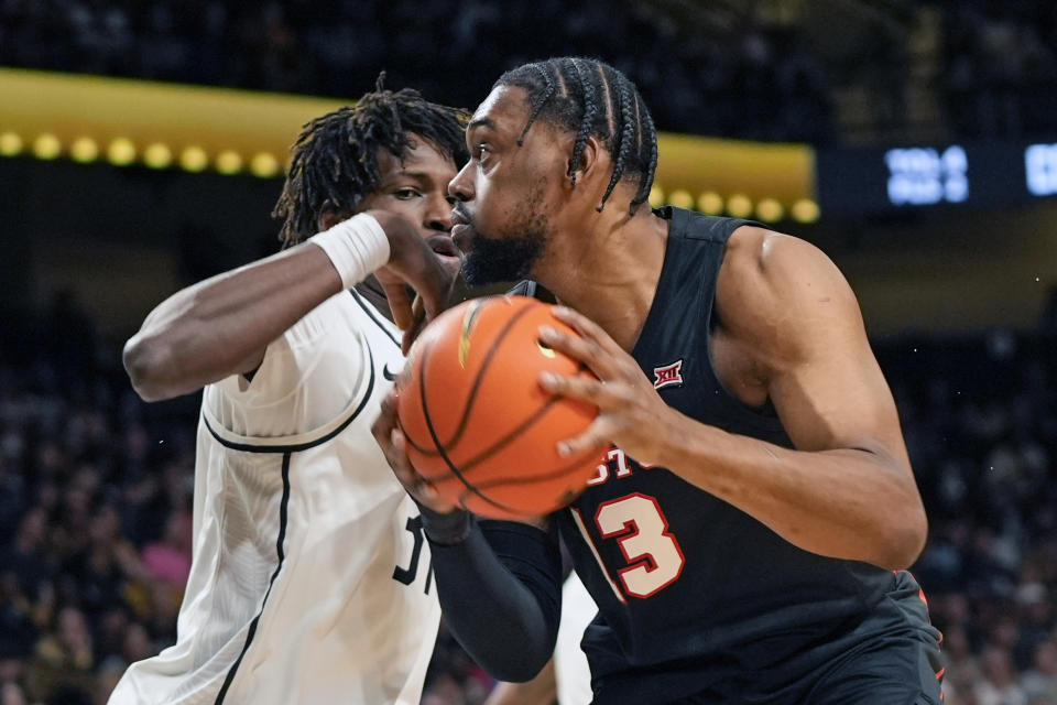 Houston forward J'Wan Roberts, right, looks for a path to the basket against Central Florida forward Thierno Sylla during the first half of an NCAA college basketball game Wednesday, March 6, 2024, in Orlando, Fla. (AP Photo/John Raoux)