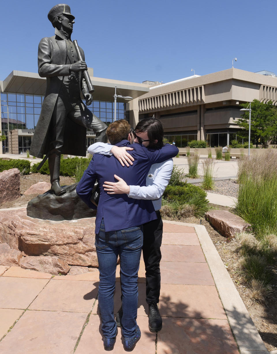 Michael Anderson, front, vice presient of operations at Club Q, is hugged by his brother, Tim, of Tampa, after a hearing for the suspect in a mass shooting at the gay nightclub Monday, June 26, 2023, in Colorado Springs, Colo. The suspect pleaded guilty in the attack that left five people dead and wounded multiple others just before Thanksgiving Day 2022, at the longtime sanctuary for the LGBTQ+ community in this mostly conservative city. (AP Photo/David Zalubowski)