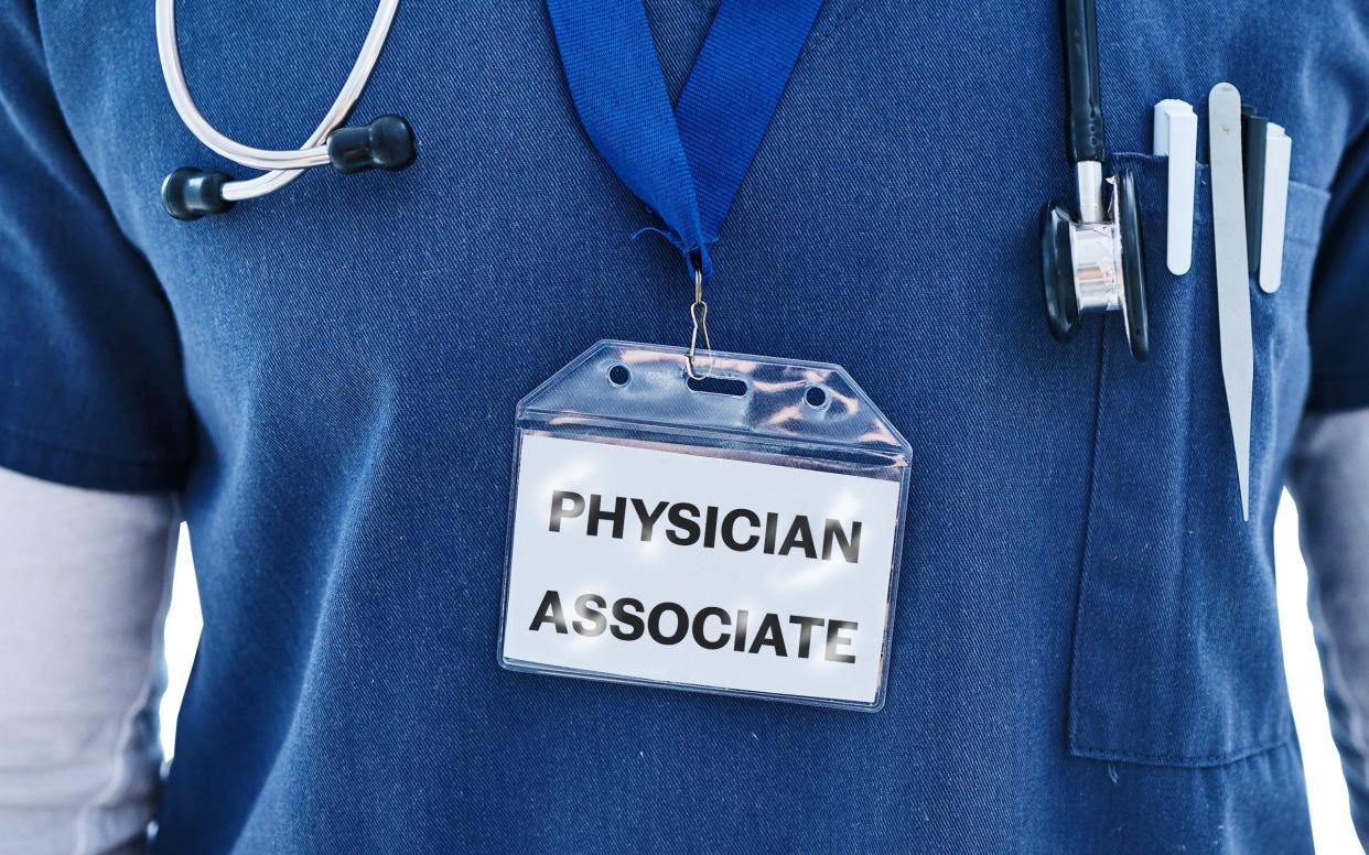 A person wearing a Physician Associate badge