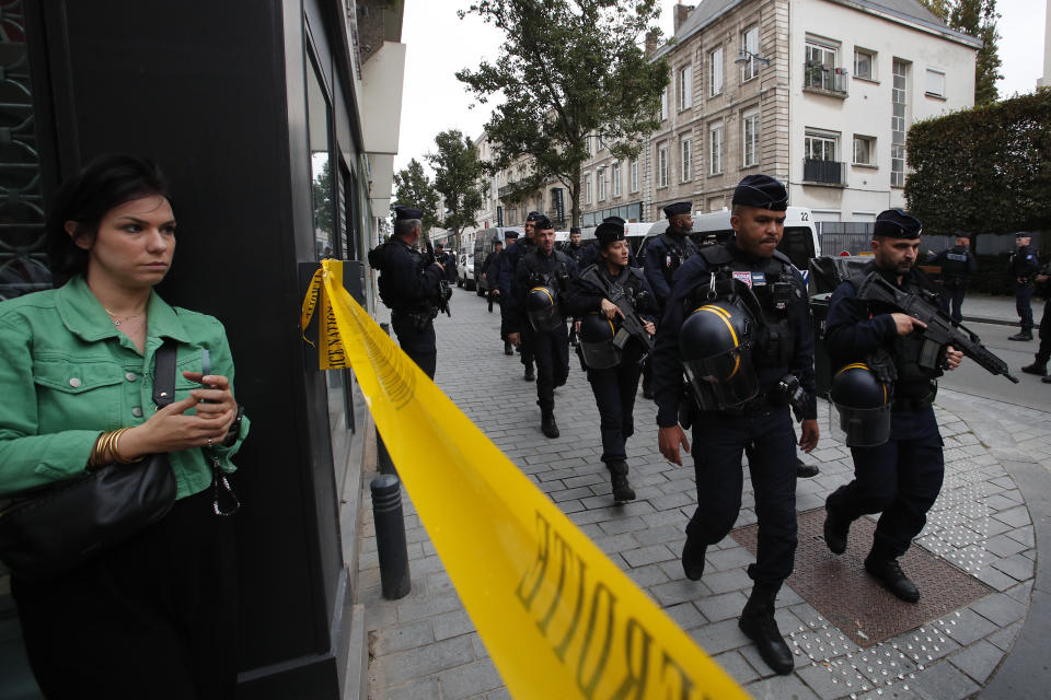 Riot police officers patrol the area after a man armed with a knife killed a teacher and wounded two others at a high school in northern France, Friday, Oct. 13, 2023 in Arras. Antiterror prosecutors said they were leading the investigation into the attack at the Gambetta high school in the city of Arras, some 115 miles (185 kilometers) north of Paris. (AP Photo/Michel Spingler)