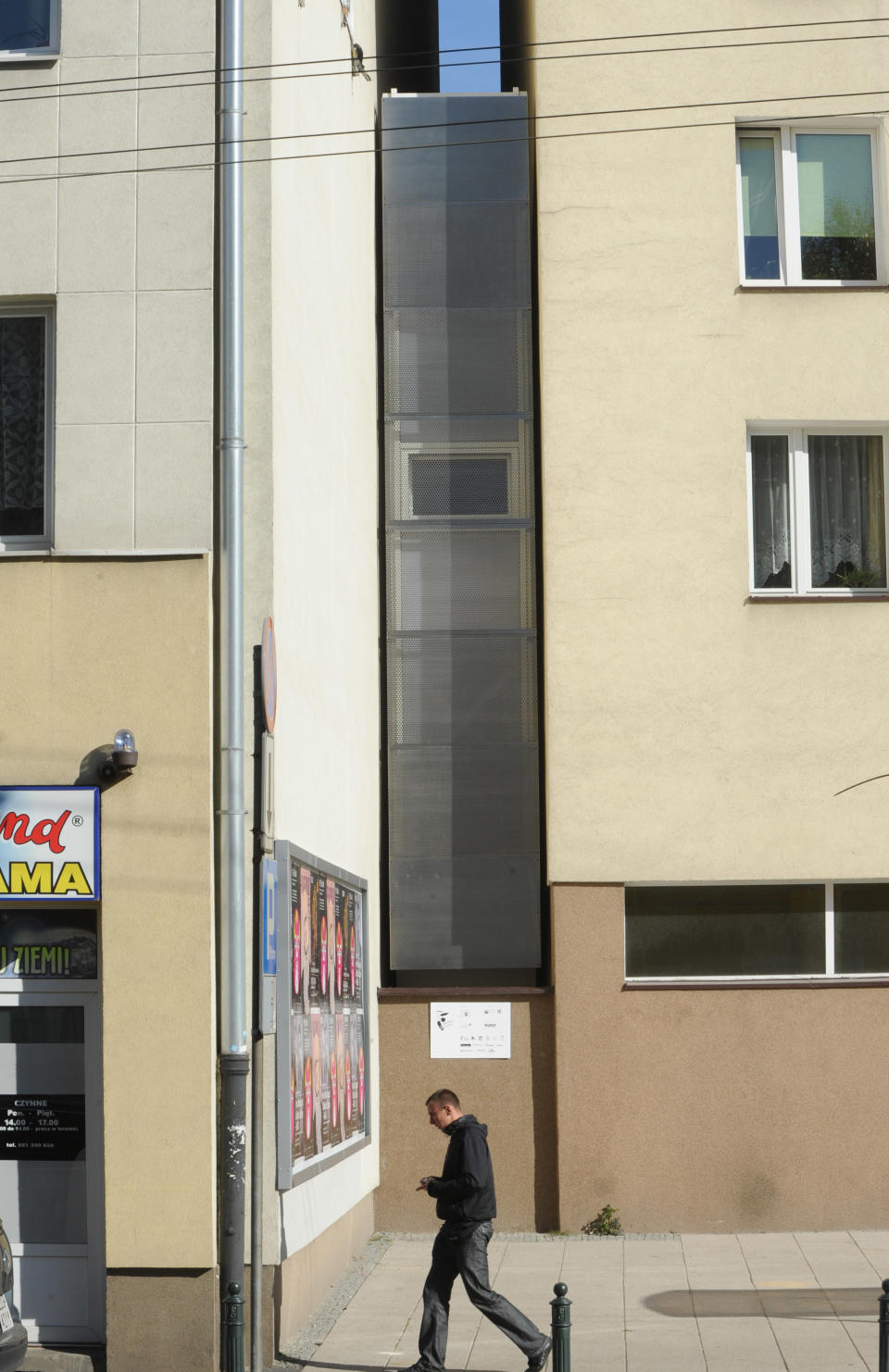 A passerby walks past one of the world’s narrowest houses, in Warsaw, Poland, Friday, Oct. 19, 2012. The two-level “Keret’s House” is no wider than 122 centimeters (48.03 inches) and was fitted into tiny space puzzlingly left between a pre-war house and a modern apartment block of the 1960s in downtown Warsaw. It is named after Etgar Keret, an Israeli writer of Polish roots who will be the first inhabitant of this artistic project of aluminum and polycarbonate. (AP Photo/Alik Keplicz)