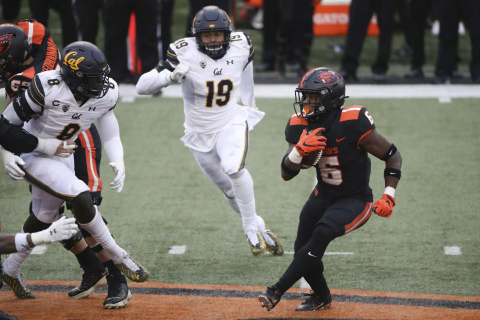 Oregon State running back Jermar Jefferson (6) looks for a path past California inside linebacker Kuony Deng (8) and outside linebacker Cameron Goode (19) during the second half of an NCAA college football game in Corvallis, Ore., Saturday, Nov. 21, 2020. Oregon State won 31-27. (AP Photo/Amanda Loman)