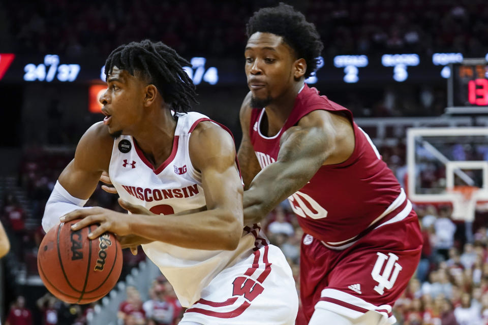 Indiana's De'Ron Davis (20) reaches in on Wisconsin's Aleem Ford (2) during the second half of an NCAA college basketball game Saturday, Dec. 7, 2019, in Madison, Wis. Wisconsin won 84-64. (AP Photo/Andy Manis)