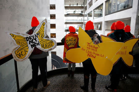 Protesters calling for an immigration bill addressing the so-called Dreamers, young adults who were brought to the United States as children, walk through the Hart Office Building on Capitol Hill in Washington, U.S., January 16, 2018. REUTERS/Joshua Roberts