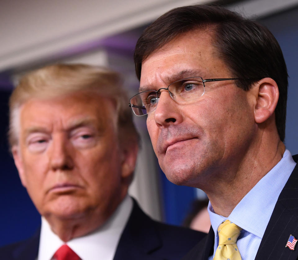 Mark Esper, U.S. secretary of defense, speaks while President Donald Trump, left, listens during a Coronavirus Task Force news conference in the briefing room of the White House in Washington, D.C. in March. (Kevin Dietsch/UPI/Bloomberg via Getty Images)