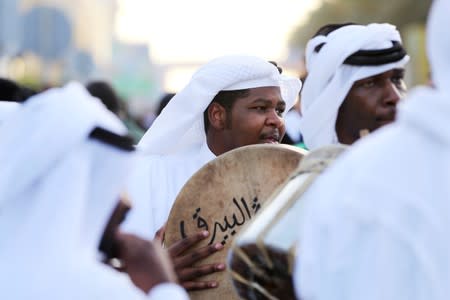 Saudi people use drums as they perform during the 89th annual National Day of Saudi Arabia in Riyadh