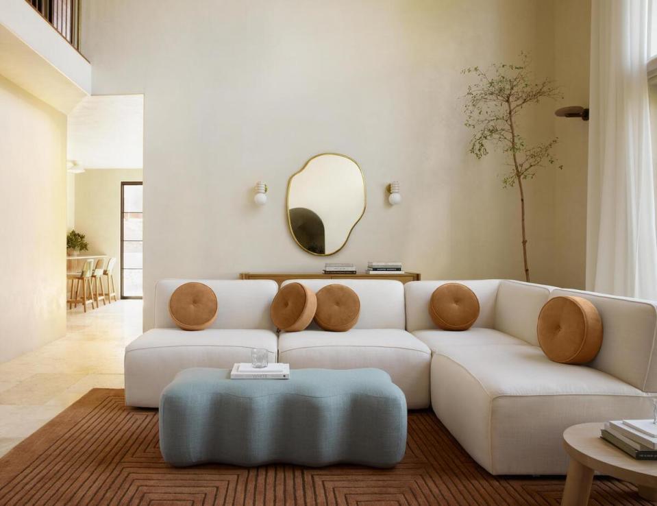 Selections from the Eny Lee Parker x Lulu and Georgia collection, including the Solana chaise sectional sofa in Ivory Linen and the June bench in Blue Linen Weave