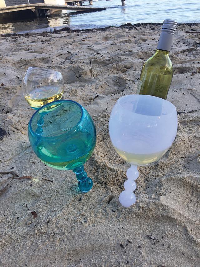 You Can Buy These Floating Wine Glasses That Stick Up In the Sand for $2 at  Aldi