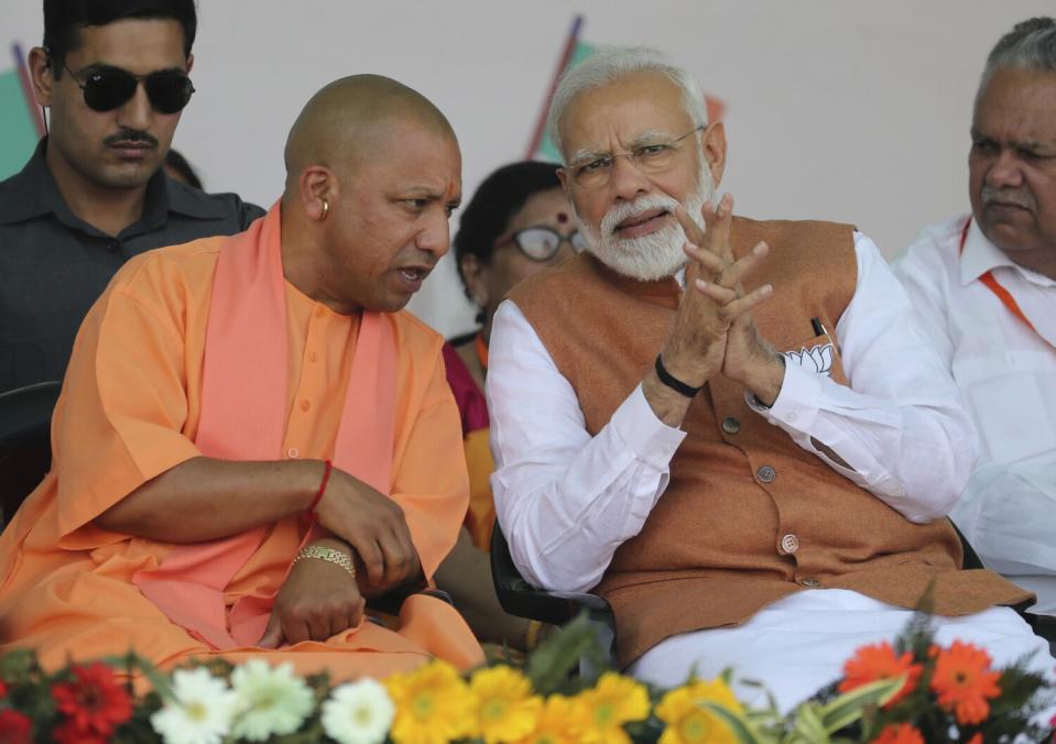 Prime Minister Narendra Modi speaks with the chief minister of Uttar Pradesh at a campaign rally in 2019.