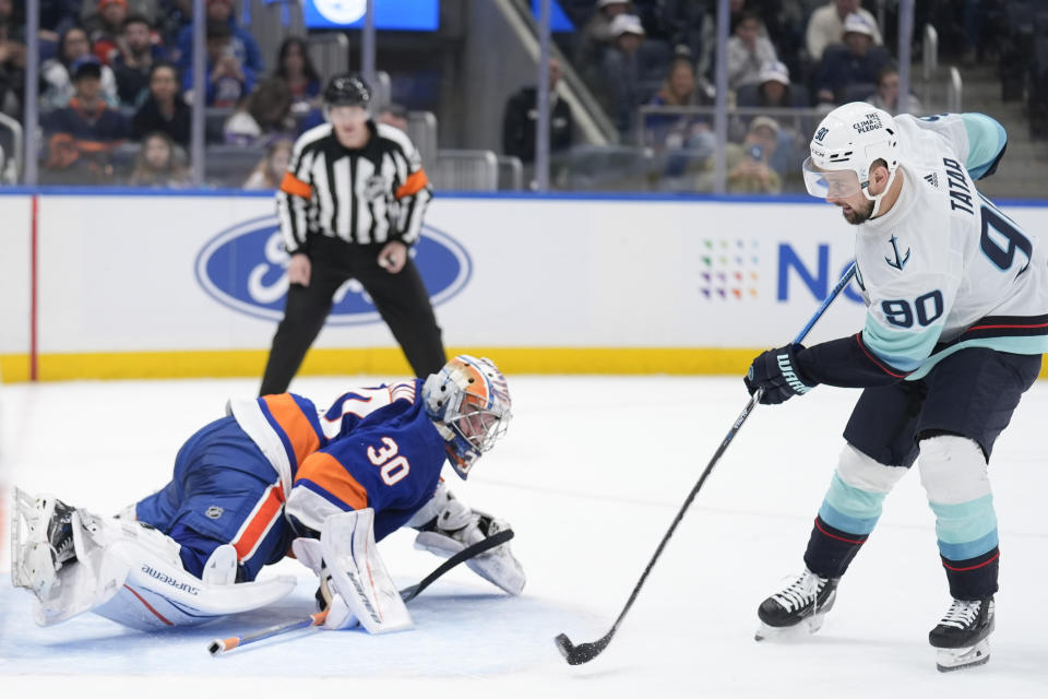 Seattle Kraken's Tomas Tatar, right, scores the winning goal past New York Islanders goaltender Ilya Sorokin during a shootout of an NHL hockey game, Tuesday, Feb. 13, 2024, in Elmont, N.Y. The Kraken defeated the Islanders in a shootout 2-1. (AP Photo/Seth Wenig)