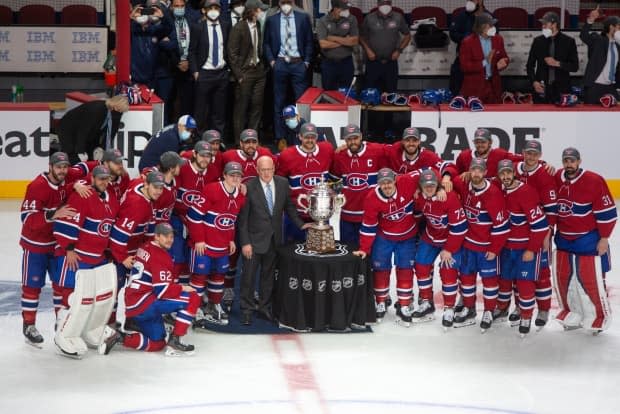 Montreal Canadiens players pose with the Clarence S. Campbell trophy on Thursday after defeating the Vegas Golden Knights to advance to the Stanley Cup final. (Ryan Remiorz/The Canadian Press - image credit)