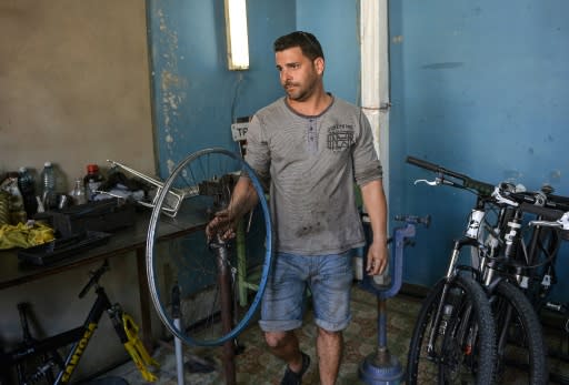 Asley Alfonso Gil works at his private bicycle repairing business in Cienfuegos province, Cuba