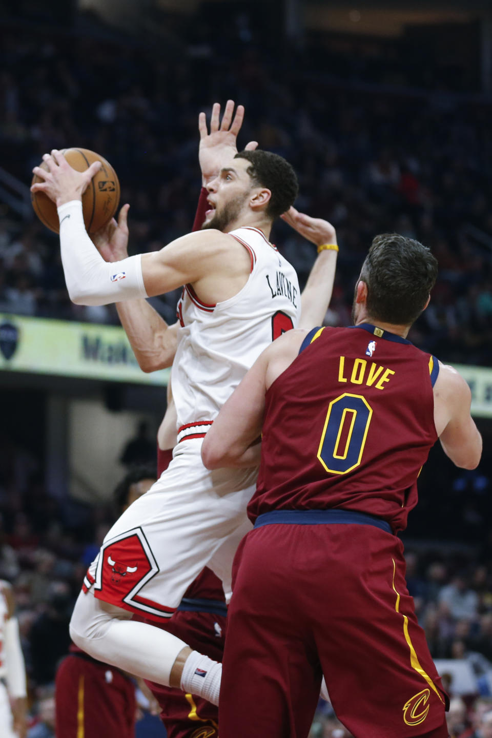 Chicago Bulls' Zach LaVine, left, goes up to shoot past Cleveland Cavaliers' Kevin Love (0) in the second half of an NBA basketball game, Saturday, Jan. 25, 2020, in Cleveland. (AP Photo/Ron Schwane)