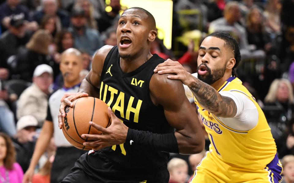 Utah Jazz guard <a class="link " href="https://sports.yahoo.com/nba/players/5636/" data-i13n="sec:content-canvas;subsec:anchor_text;elm:context_link" data-ylk="slk:Kris Dunn;sec:content-canvas;subsec:anchor_text;elm:context_link;itc:0">Kris Dunn</a> (11) is held by Los Angeles Lakers guard D’Angelo Russell (1) as the Utah Jazz and the Los Angeles Lakers play at the Delta Center in Salt Lake City on Wednesday, Feb. 14, 2024. | Scott G Winterton, Deseret News