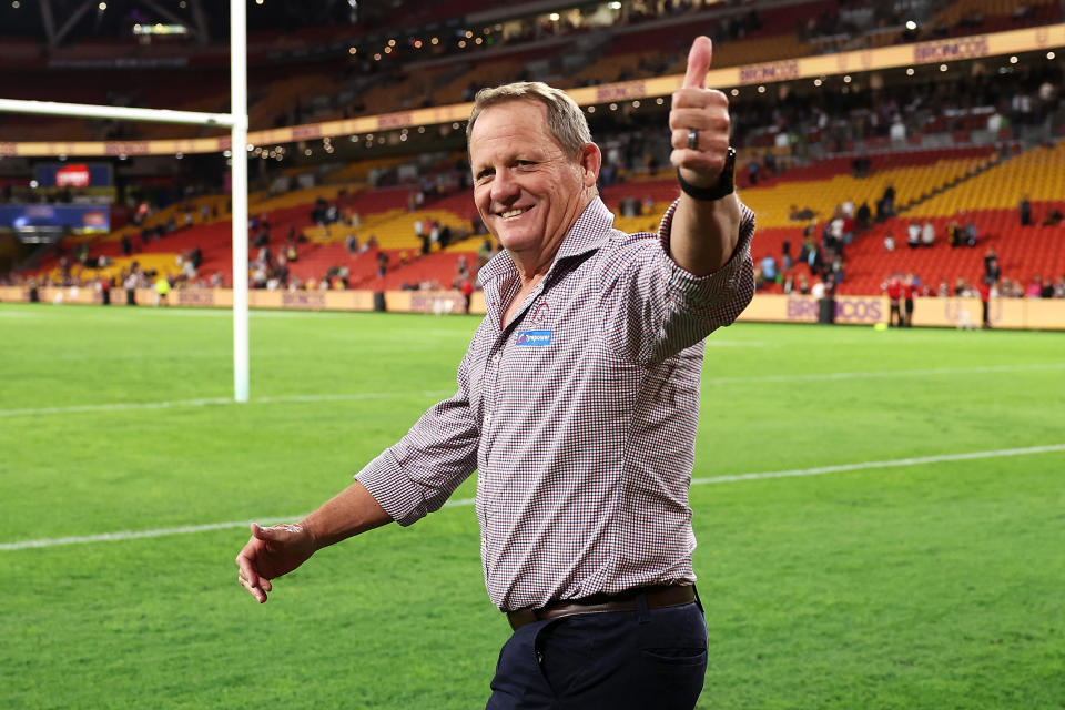 Broncos coach Kevin Walters greets the fans.