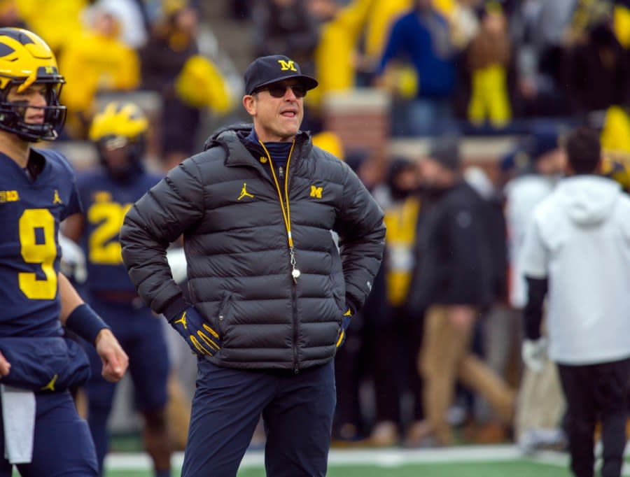 FILE – Michigan head coach Jim Harbaugh watches warmups before an NCAA college football game against Ohio State in Ann Arbor, Mich., Saturday, Nov. 27, 2021. Michigan won 42-27. (AP Photo/Tony Ding, File)