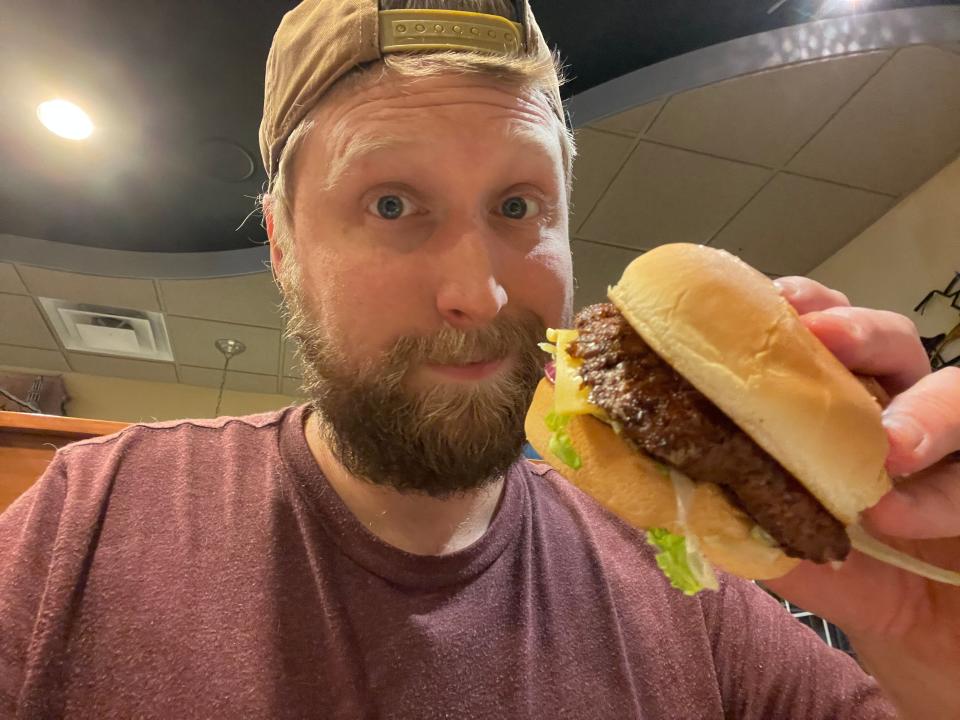 tim posing with a butterburger from culvers