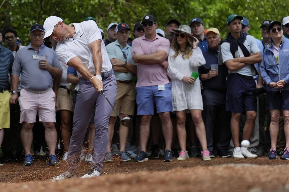 Rory McIlroy, of Northern Ireland, hits from the pine straw on the second hole during the first round at the Masters golf tournament at Augusta National Golf Club Thursday, April 11, 2024, in Augusta, Ga. (AP Photo/Ashley Landis)