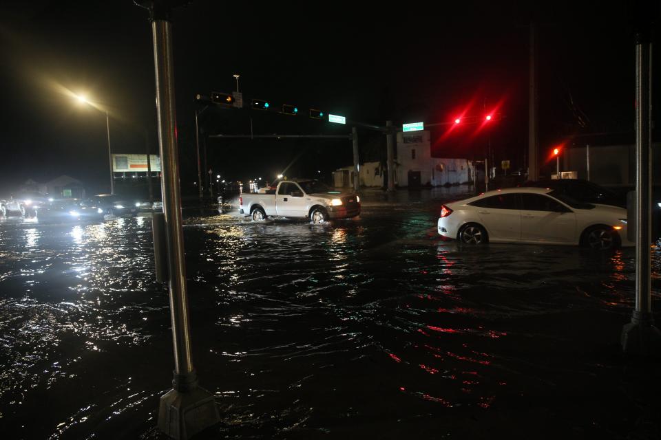 Traffic navigates flooded streets in Fort Myers on Monday, Jan. 15, 2024. Parts of Cape Coral, North Fort Myers and Fort Myers saw a deluge of rain over a short period of time this evening.