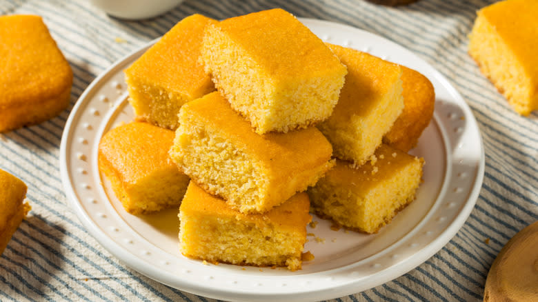 Stack of cornbread squares on a white dish