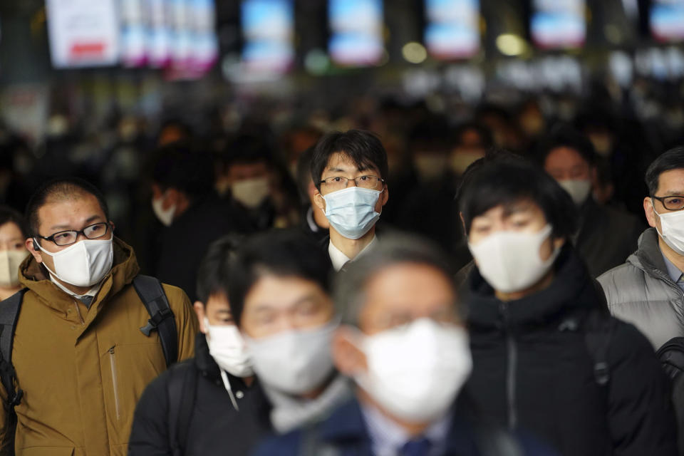 FILE - In this Jan. 4, 2021, file photo, some people commute on the first business day of the year at a train station, in Tokyo. Japan on Friday, April 23, declared a state of emergency to curb a rapid coronavirus resurgence, the third since the pandemic began. The measures in parts of Japan, including Tokyo, have so far failed to curb infections caused by a more contagious new variant of the virus. (AP Photo/Eugene Hoshiko, File)