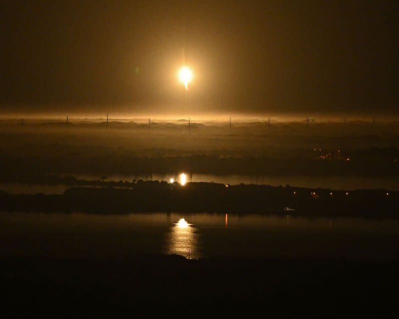 A SpaceX Falcon 9 first stage returns to Landing Zone 1 after launching its Cargo Dragon spacecraft with NASA's Crew 8 to the International Space Station at 10:53 p.m. from Launch Complex 39A at the Kennedy Space Center, Fla., on Sunday. Photo by Joe Marino/UPI